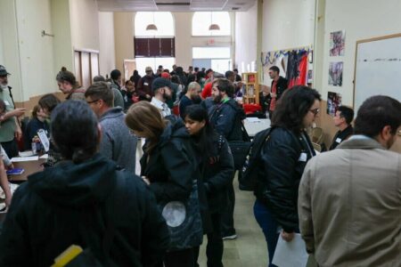 A photo of the inside of Unite-HERE Local 2 HQ during the socialist job fair. It is packed with dozens of people.
